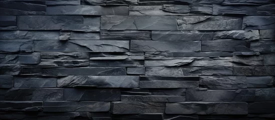 Photo sur Plexiglas Vieil immeuble A black stone wall is prominently displayed in this black and white composition. The texture and pattern of the aged slate are striking against the monochromatic tones.