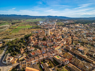 Fototapeta na wymiar Immerse yourself in the picturesque landscapes of Llagostera's medieval towns, captured in stunning aerial images along Costa Brava. 