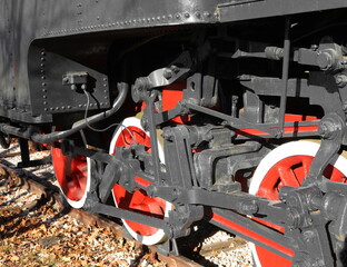 detail of red and white wheels of the old black one.train steam locomotive