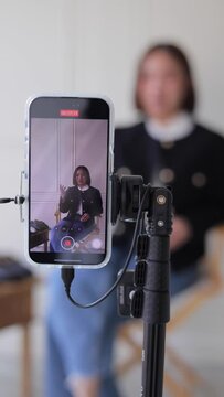 A woman is teaching live online.