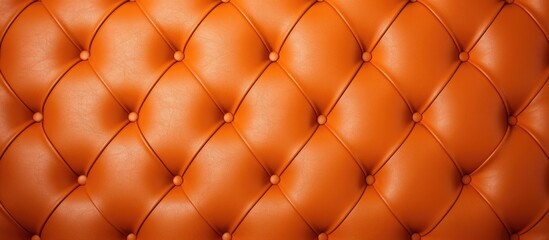 A vintage orange leather upholstered wall with button detailing, creating a textured backdrop. The genuine leather material is scratched, adding character to the design.