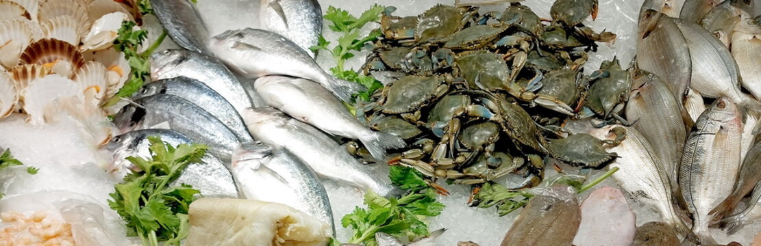 lots of fish and even very fresh blue crabs on the counter full of ice  in the fishmongers