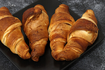 Freshly baked croissants, isolated on white background. 