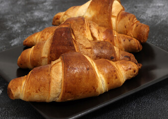 Freshly baked croissants, isolated on white background. 