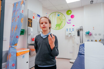 Pediatric Healthcare: Girl with Injured Finger in Hospital Room