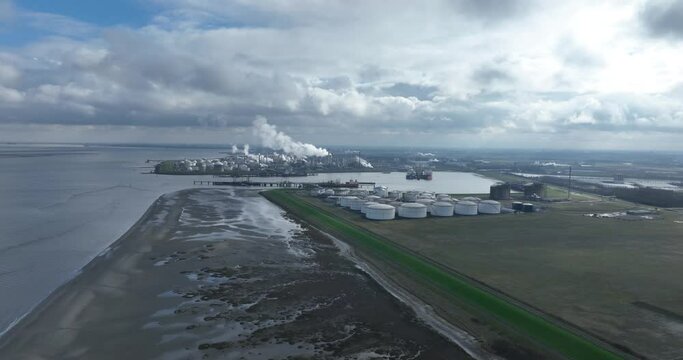 Chemical industry at terneuzen. DOW chemical park and petrochemical storage containers. Smokestacks and heay industry. Birds eye aerial drone view.