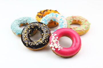 Sweet strawberry glazed donuts with sprinkles on white background, Delicious colorful donuts isolated on white background With clipping path.