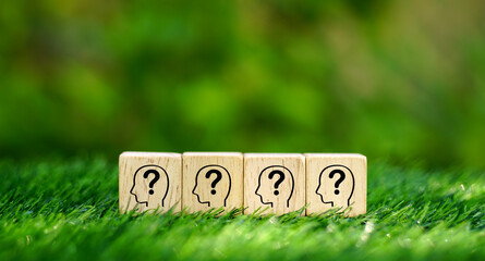 Many human head symbol with question mark on wooden cubes with arranged in straight rows. Creative...