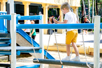 Cute preschooler boy playing on the Playground. High quality photo