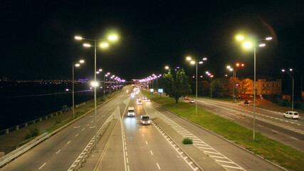 Multi-lane road in Kyiv at night. Illuminated street of evening city