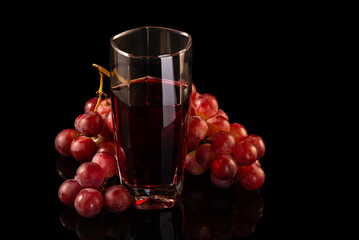 Red grape and juice in glass  isolated on black background. - 748962779