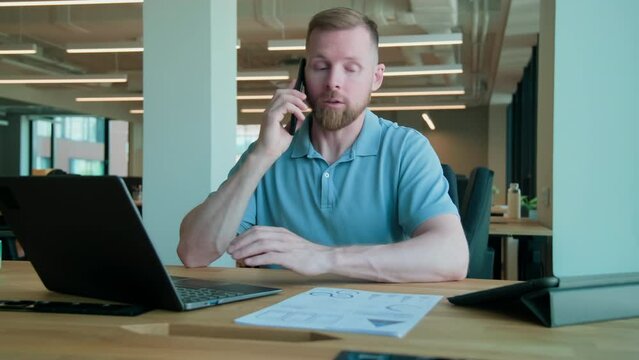 Manager talking with client on mobile phone at office