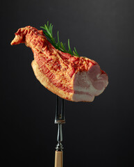 Smoked pork with rosemary on a fork.