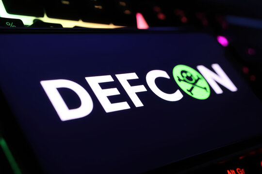 Viersen, Germany - February 9. 2024: Closeup of smartphone with logo lettering of Defcon hacker convention conference on computer keyboard