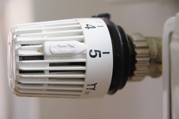 A white thermostat with the numbers 1 through 5 on it - 748987395
