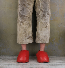 man in old pants and red slippers