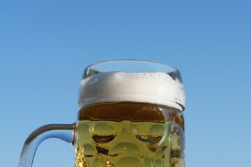 A glass of beer with foam on top - 748988307