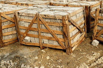 A pile of wooden crates with a white brick inside - 748988542