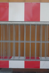 A red and white striped fence with a white stripe in the middle - 748988729