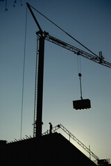 A crane is lifting a large object - 748988963