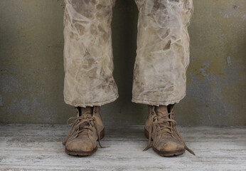 legs of a man in old pants and old shoes - Powered by Adobe