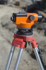 A red and silver tripod with a black and orange top - 748989556