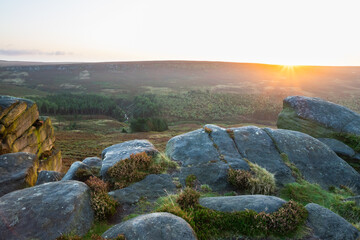 Higger Tor sunrise in the Peak District UK with rocks in foreground
