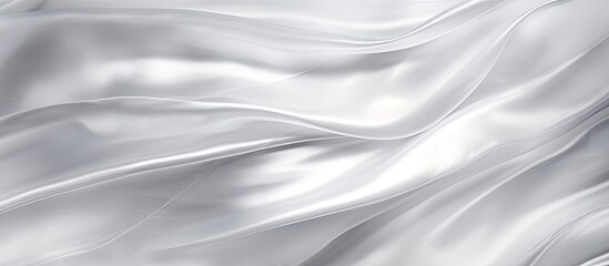Fototapeta premium This close-up view showcases the smooth, shiny texture of a white satin fabric. The fabric reflects light beautifully, creating an elegant and luxurious appearance.