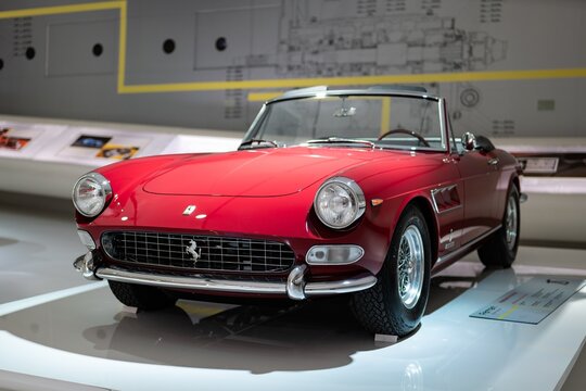 Front view of Ferrari 275 GTS red convertible sports car in Museum Enzo Ferrari Modena