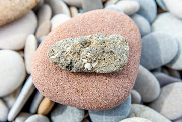 Variegated Stone on Smooth Reddish Pebble Background