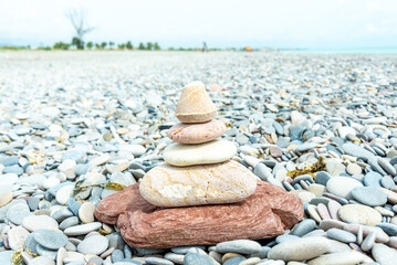 Obraz na płótnie Canvas Harmonious Stack of Zen Stones on Pebbled Beach