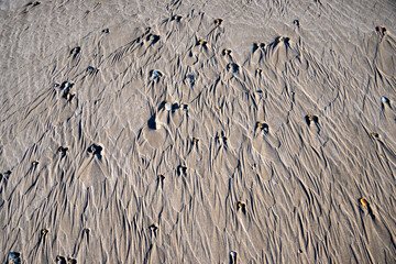 Natural Sand Patterns with Pebbles on a Beach