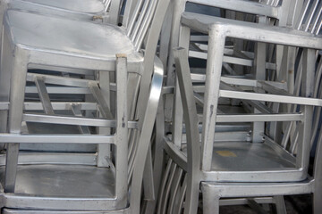Large stacks of outdoor aluminium chairs
