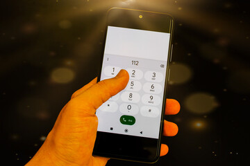 man calling 112 for an emergency. It says "urgent call" on the screen. Closeup of a hand holding smartphone or smart phone. 112: Emergency call number in Turkey. Emergency service occupation. 