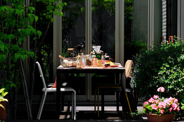 Dining table on sunny terrace ready for lunch