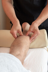 Sports massage. Massage therapist massaging legs of an athlete in health, beauty salon, spa. Concept: relaxing, healthy, acupressure treatment. Self care, me time, enjoying time, perfect gift.