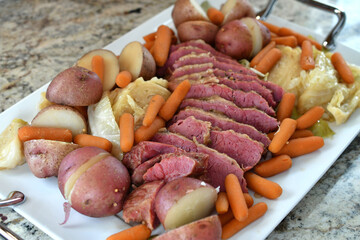 A traditional St. Patrick's Day meal of corned beef and cabbage arranged on a platter