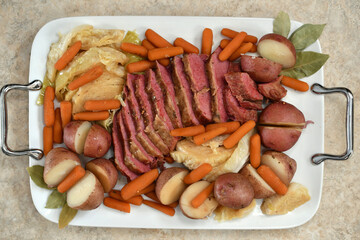 A traditional St. Patrick's Day meal of corned beef and cabbage arranged on a platter