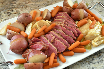 A traditional St. Patrick's Day meal of corned beef and cabbage arranged on a platter