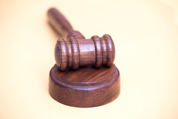 Judge's gavel on yellow background