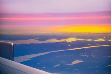 Dramatic Sunset Cloudscape and airplane wing, a view over Seoul Incheon International Airport, South Korea, a tranquil high altitude scenery at twilight
