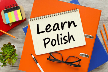learn Polish Top view of empty notepad and various office supplies on wooden table
