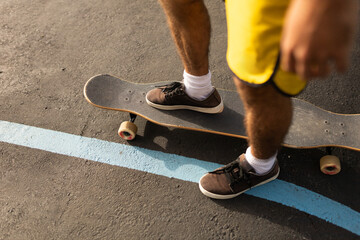 man skating in skatepark at sunrise with longboard cap and short hair - Powered by Adobe