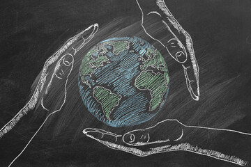 Rotating globe with male palms hand drawn in chalk on a school blackboard. Save our planet.