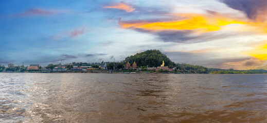 Fototapeta na wymiar Golden Triangle the 3 borders of Thailand Laos and Myanmar lovely Golden Buddha on the Mekong River with boats in the river and mountains in the background 