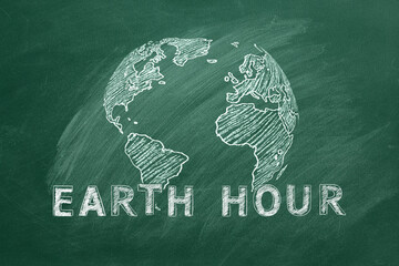 Rotating globe with lettering EARTH HOUR hand drawn in chalk on a school greenboard. Save the World. Save our planet.