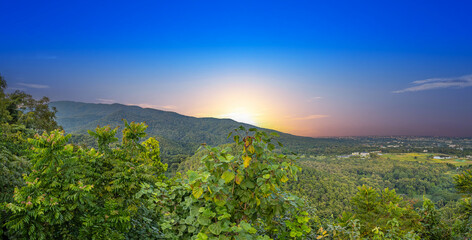 Panorama view of Chiangmai Chiang Mai city taken from Doi Suthep Mountains. Lovely views of the Old city at Sunset Sunrise lovely tropical mountains and beautiful nature in the foreground