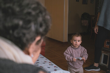 great-grandmother looks at her granddaughter
