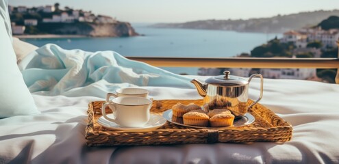 Fototapeta na wymiar tea and cake on a tray on a bed with views