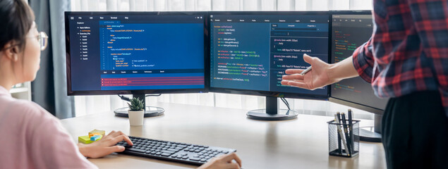 Young Professional website developer and cooperative computer engineer team brainstorming and sharing idea of program writing and coding at modern meeting room. Teamwork concept. Closeup. Burgeoning.